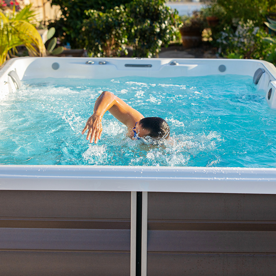 Man swimming in R500 Series Endless Pools Swim Spa