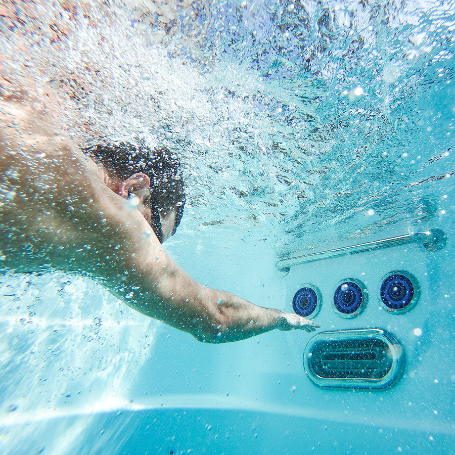 Man swimming underwater using Endless Pools SwimCross X500