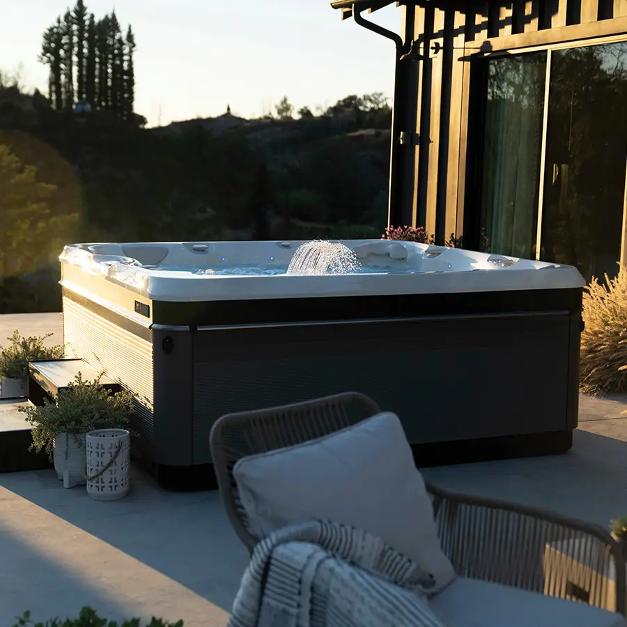 Image of Caldera Utopia Niagara Hot Tub shown in backyard with water feature on