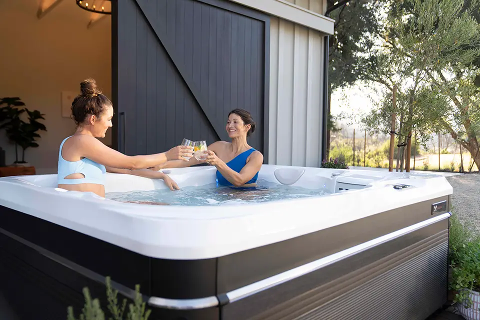 Person relaxing in a hot tub after work, steam rising