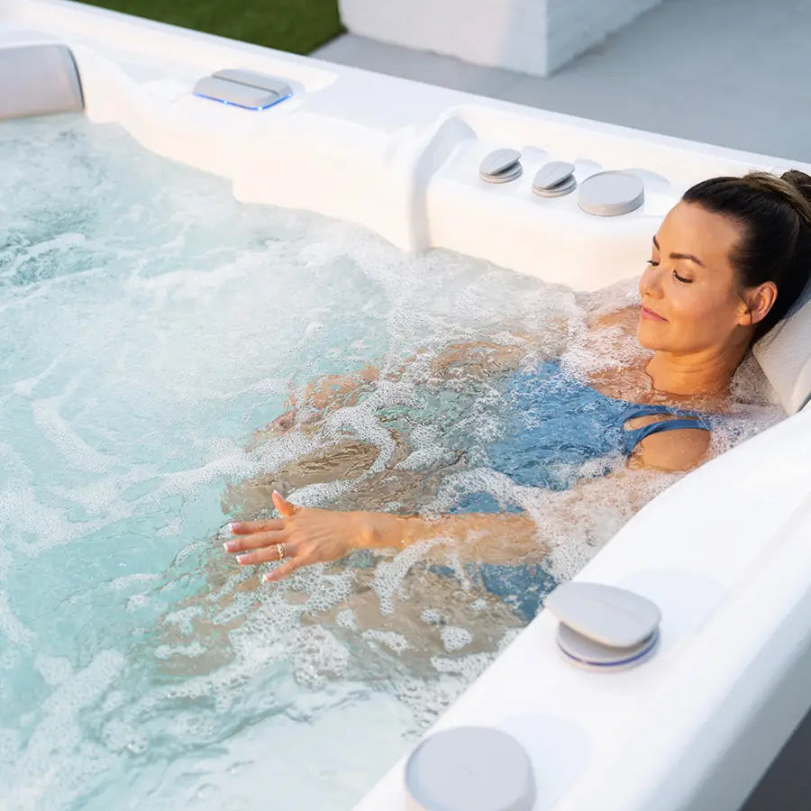 Woman relaxing using a Grandee Hot Tub