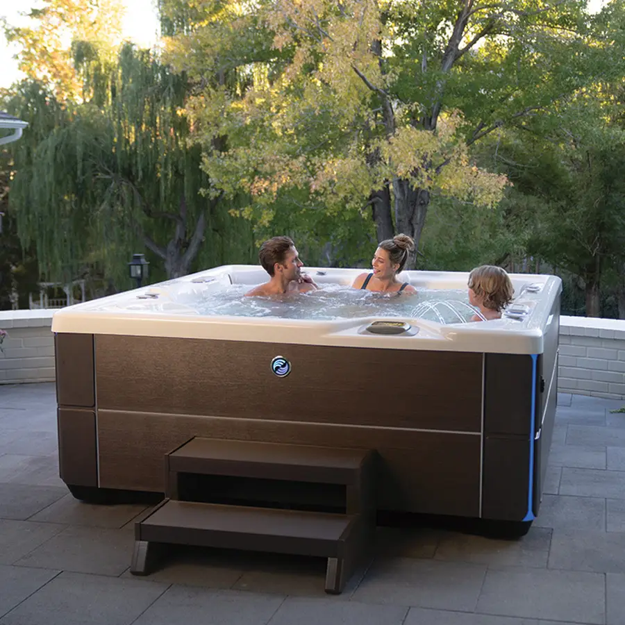 Image of family using HotSpring Highlife Vanguard Hot Tub in backyard