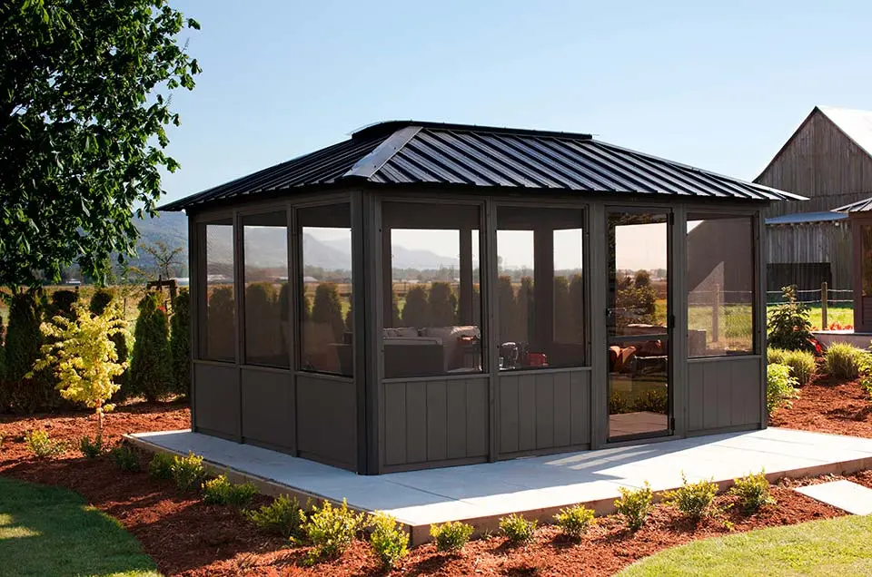 Wooden gazebo with decorative roof in a backyard