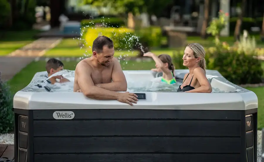 Family enjoying an outdoor hot tub together on a sunny afternoon