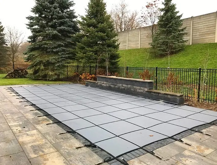 Pool with water feature at night