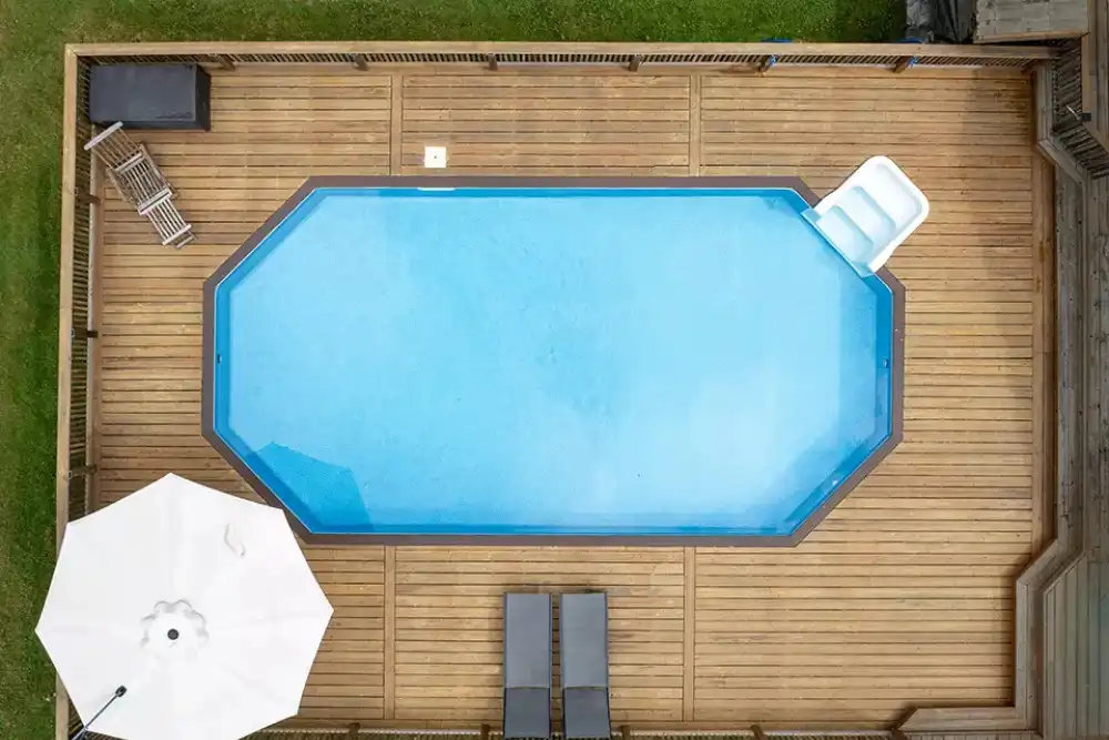 Onground pool with timber deck and landscaping