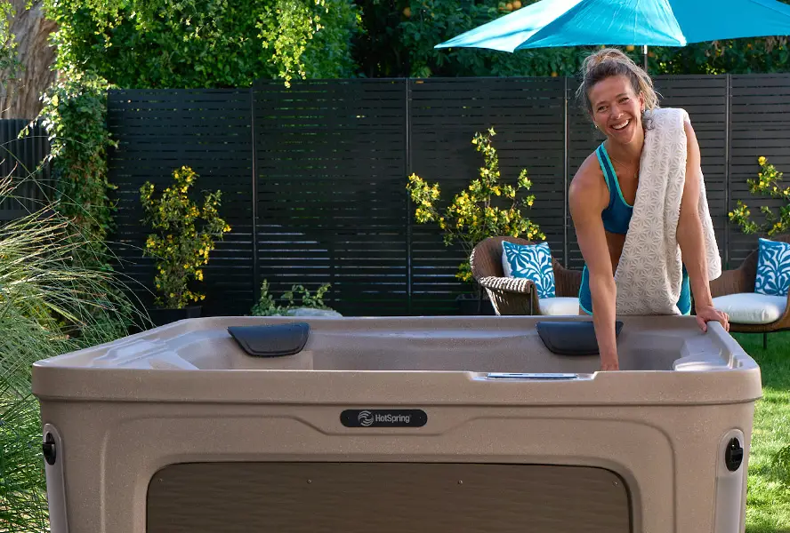 A refurbished hot tub looking clean and renewed in a backyard