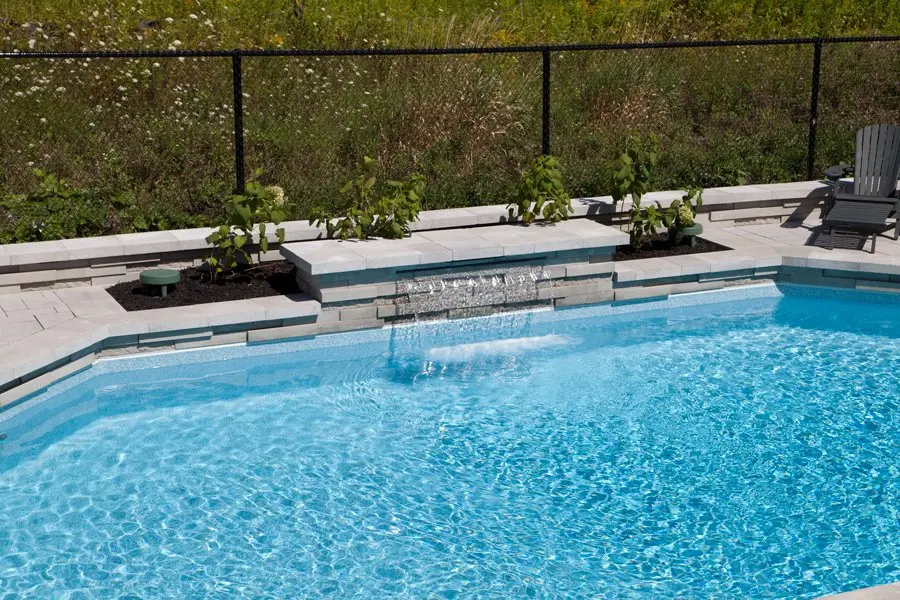 Pool with water feature at night
