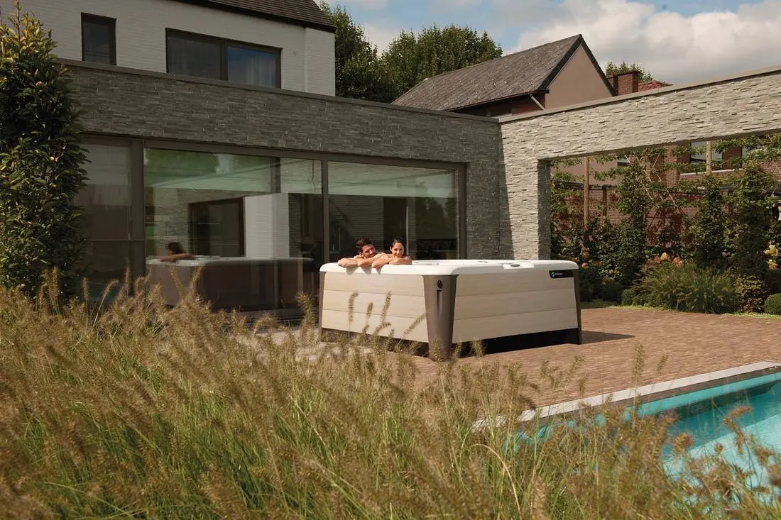 Person relaxing in a hot tub after work, steam rising
